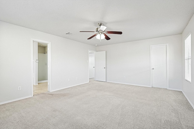 2121 Franks St, Fort Worth, TX 76177 - unfurnished bedroom featuring light colored carpet, a textured ceiling, baseboards, and ceiling fan