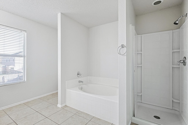 bathroom with independent shower and bath, a textured ceiling, and tile patterned floors