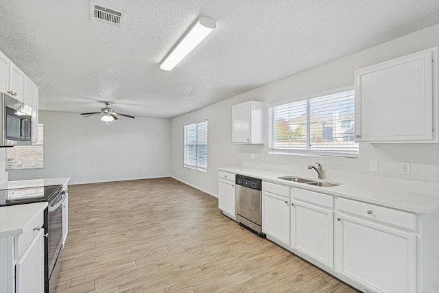 2121 Franks St, Fort Worth, TX 76177 - kitchen featuring a sink, appliances with stainless steel finishes, a textured ceiling, a ceiling fan, and light countertops