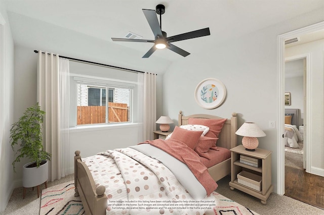 bedroom featuring a ceiling fan, lofted ceiling, visible vents, and baseboards