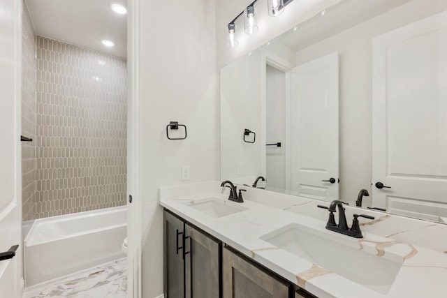 bathroom with tub / shower combination, a sink, toilet, and double vanity