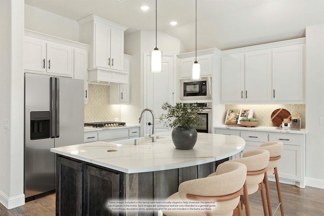 kitchen featuring white cabinets, stainless steel appliances, a sink, and wood finished floors