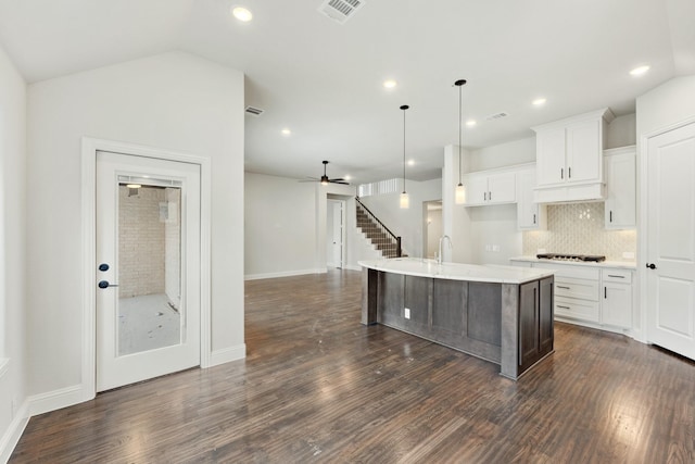 kitchen with lofted ceiling, dark wood-style floors, and visible vents