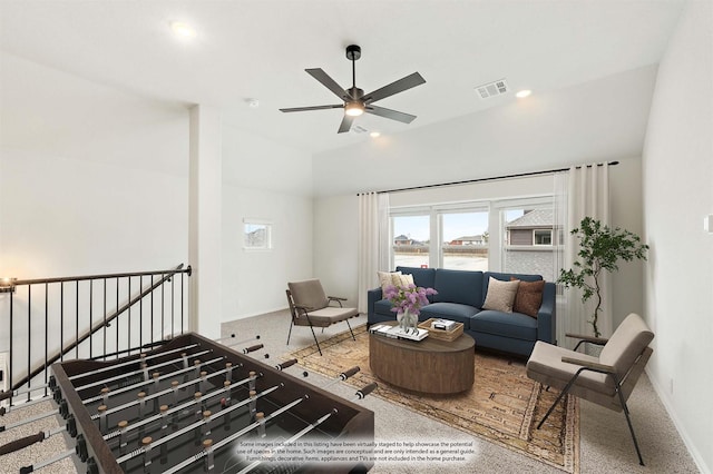 interior space with lofted ceiling, baseboards, visible vents, and ceiling fan