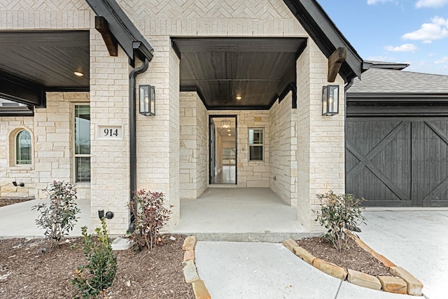 view of exterior entry featuring covered porch and brick siding