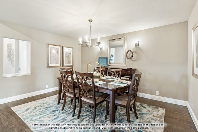 dining room with dark hardwood / wood-style flooring and a chandelier