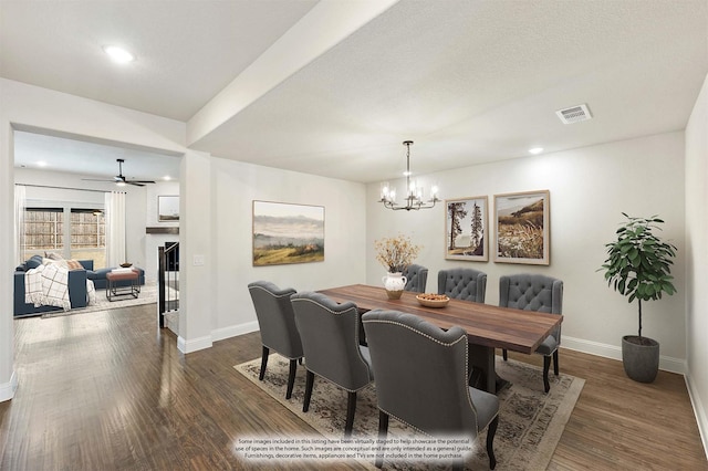 dining space with dark wood-style floors, baseboards, and visible vents