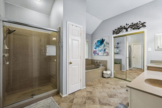 bathroom featuring vanity, independent shower and bath, and vaulted ceiling