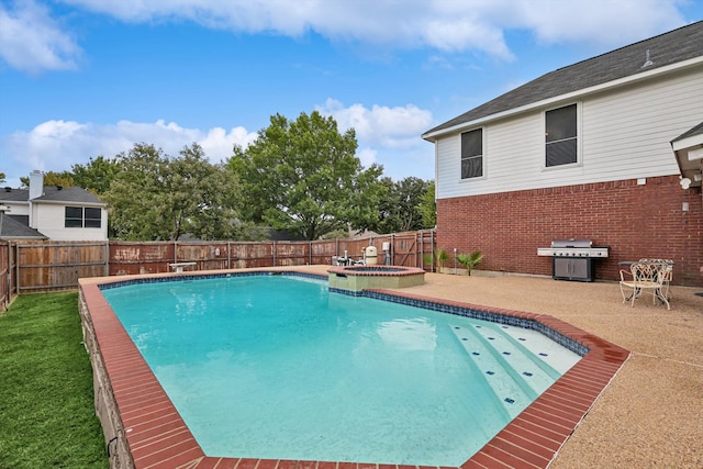 view of swimming pool featuring a patio, an in ground hot tub, and grilling area