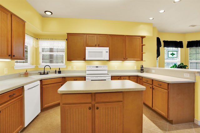 502 Smith Oak Rd, Sherman, TX 75090 - kitchen with white appliances, a sink, a peninsula, light tile patterned floors, and recessed lighting
