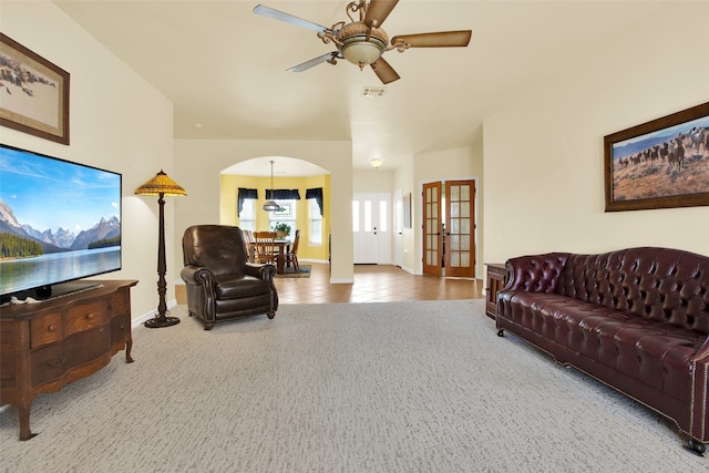 living room featuring carpet, ceiling fan, and french doors