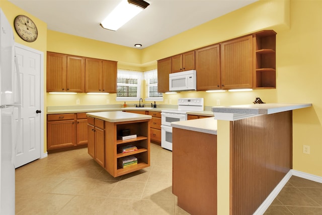 kitchen featuring a kitchen island, sink, light tile patterned floors, kitchen peninsula, and white appliances