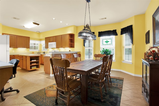 tiled dining space featuring sink