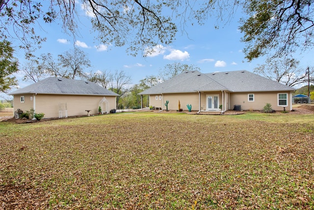 back of house featuring a yard and french doors