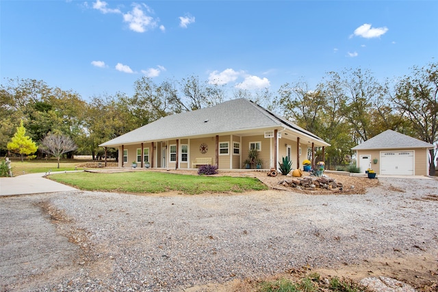 view of front of home with a garage, a front yard, and a porch