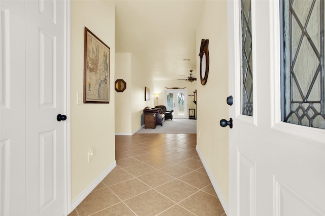 tiled entryway featuring ceiling fan