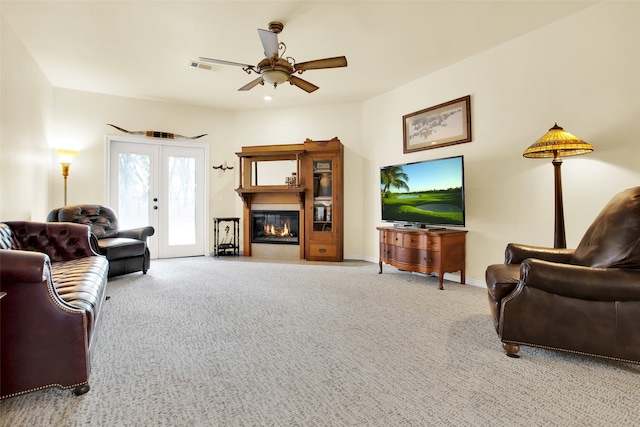 living room featuring french doors, ceiling fan, and carpet