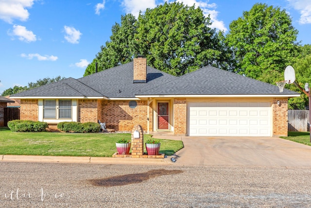 view of front of home featuring a front yard and a garage