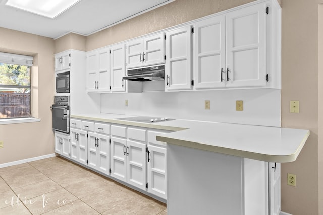 kitchen with black appliances, white cabinets, kitchen peninsula, and light tile patterned floors