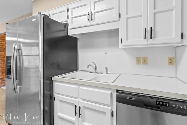 kitchen with white cabinetry, appliances with stainless steel finishes, and sink