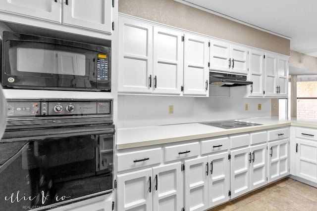 kitchen with black appliances, white cabinetry, and light tile patterned floors