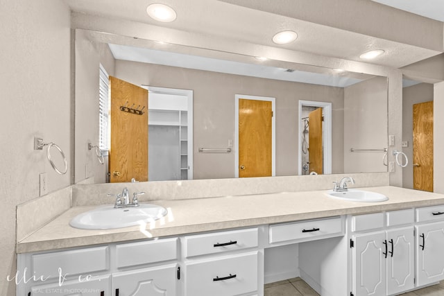 bathroom with vanity and tile patterned flooring