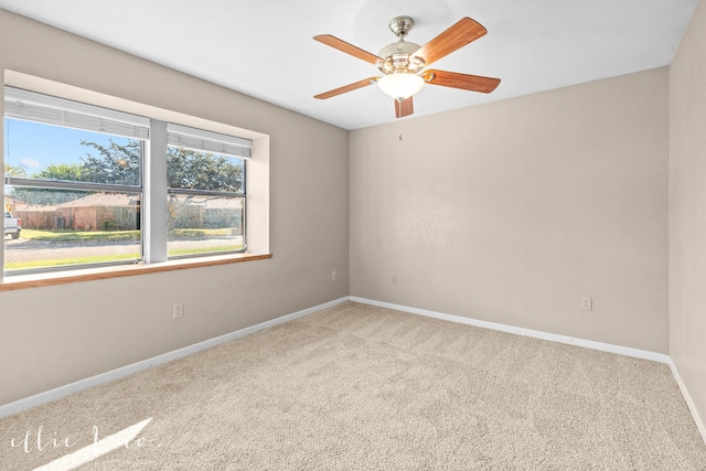 spare room with light carpet and ceiling fan