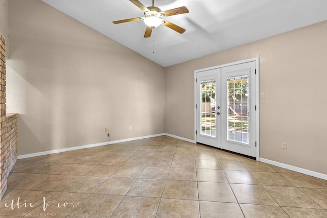 tiled spare room featuring french doors, lofted ceiling, and ceiling fan