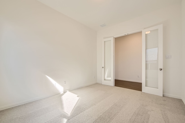 carpeted empty room with french doors