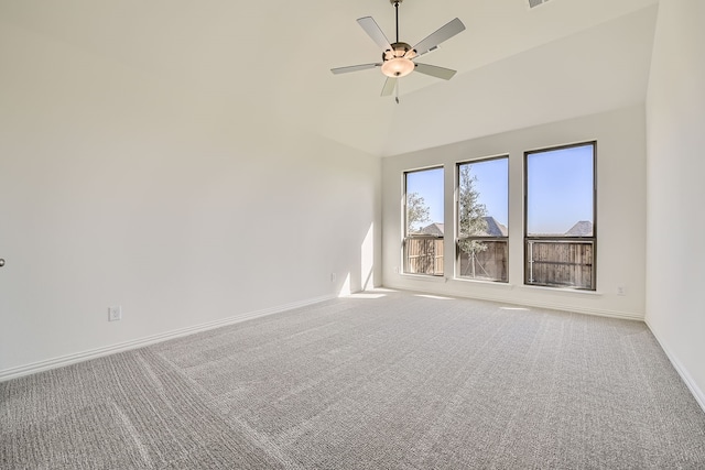 empty room featuring carpet flooring, ceiling fan, and a high ceiling