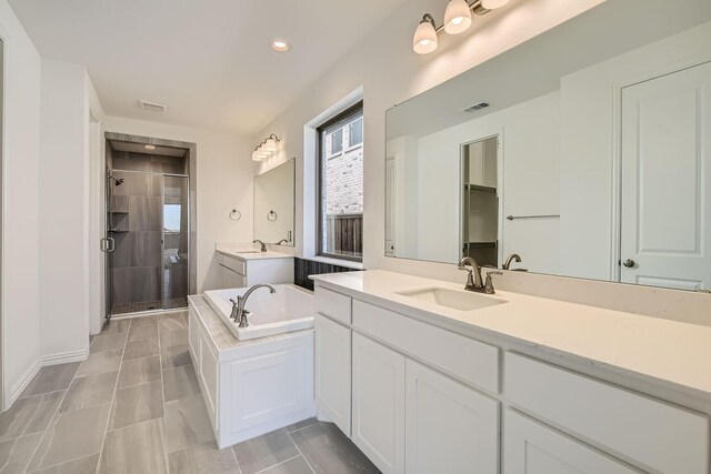 bathroom featuring vanity, tile patterned flooring, and plus walk in shower