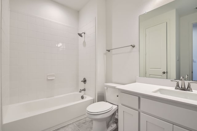 full bathroom with vanity, tile patterned floors, tiled shower / bath combo, and toilet