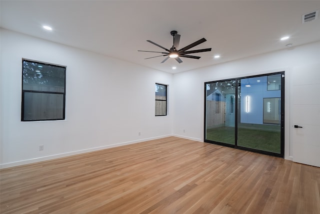 empty room featuring ceiling fan and light hardwood / wood-style flooring