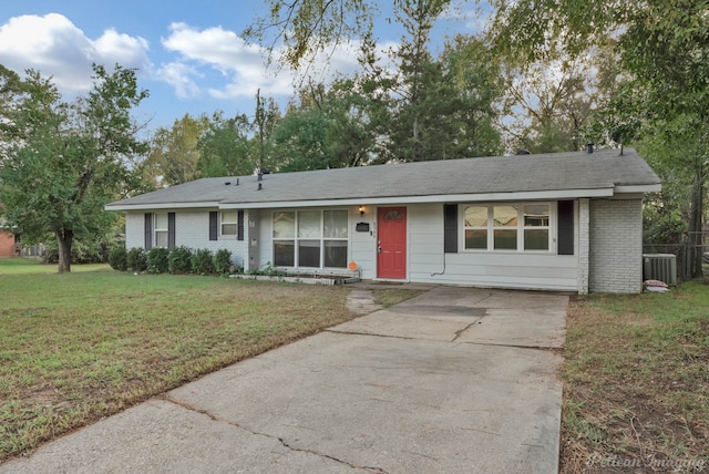 ranch-style home featuring cooling unit and a front yard