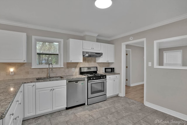 kitchen with sink, ornamental molding, light stone countertops, white cabinetry, and appliances with stainless steel finishes