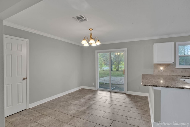 unfurnished dining area featuring a chandelier, light tile patterned floors, and a healthy amount of sunlight