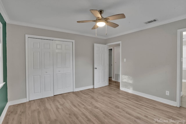 unfurnished bedroom featuring a closet, ceiling fan, ornamental molding, and light hardwood / wood-style flooring