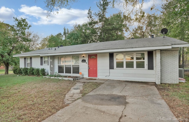 ranch-style house with central AC unit and a front yard