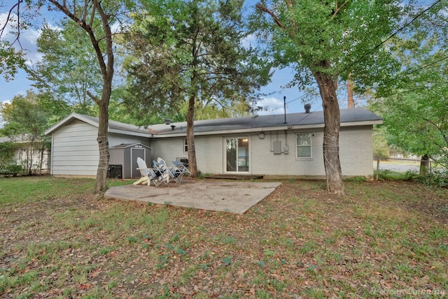 back of property featuring a storage shed and a patio