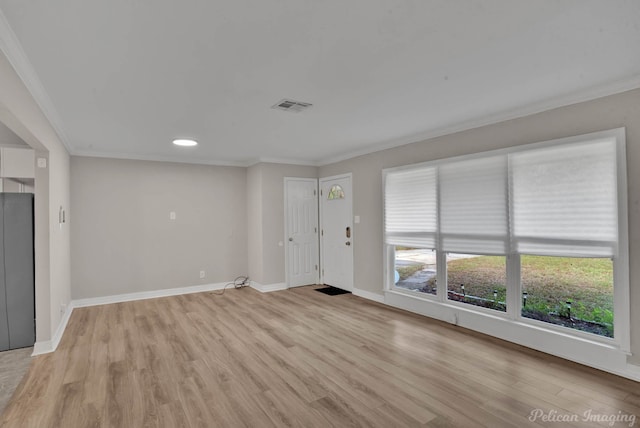 unfurnished living room with ornamental molding and light wood-type flooring