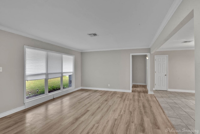 empty room with light hardwood / wood-style flooring and ornamental molding