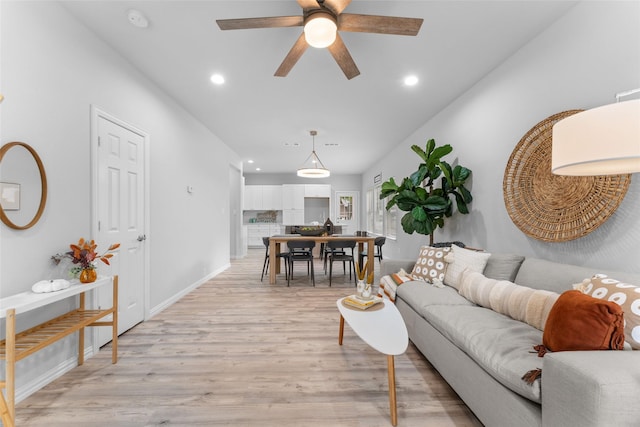 living room with ceiling fan and light hardwood / wood-style floors