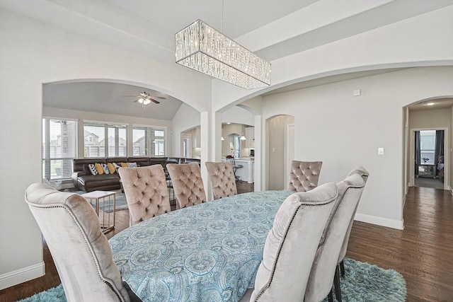 dining room featuring lofted ceiling, dark hardwood / wood-style floors, and ceiling fan with notable chandelier