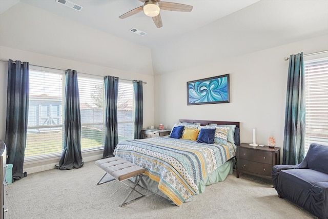 carpeted bedroom with ceiling fan and vaulted ceiling