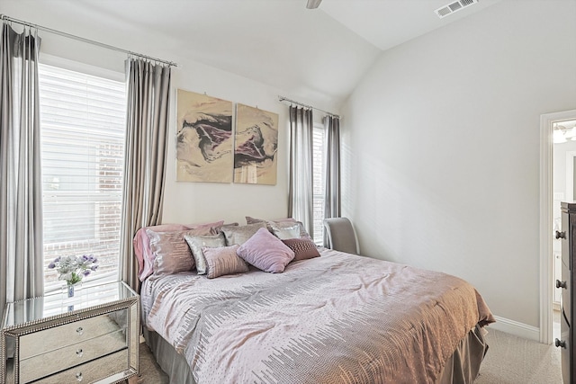 bedroom featuring vaulted ceiling, multiple windows, and carpet floors