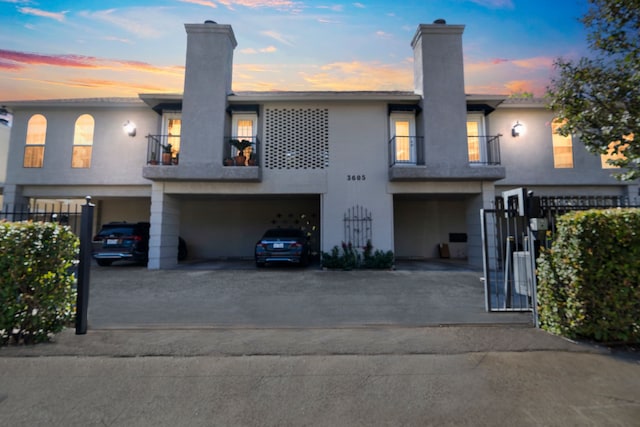 view of front of home with a balcony and a garage