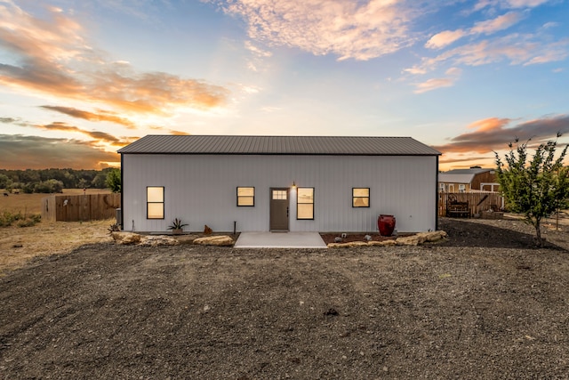 view of back house at dusk