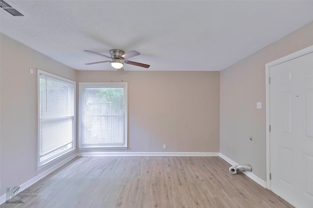 unfurnished room with light wood-type flooring and ceiling fan