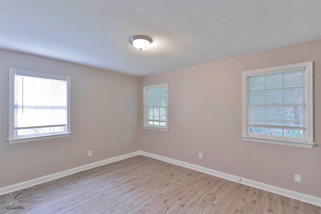 spare room with light hardwood / wood-style floors