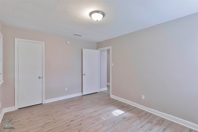 spare room featuring light hardwood / wood-style flooring